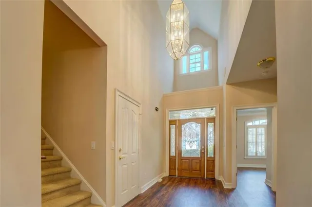 a view of an entryway with wooden floor and windows