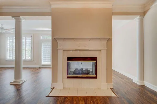 a living room with a fireplace and wooden floor