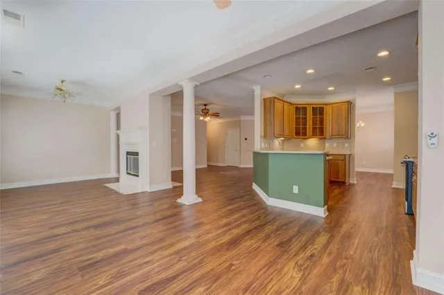a view of a kitchen with wooden floor and a kitchen