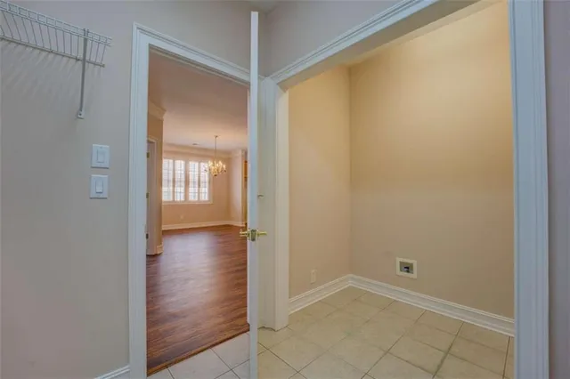 a view of a hallway with wooden floor and closet area