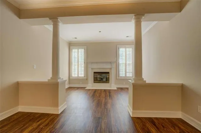 a view of a livingroom with wooden floor and a fireplace