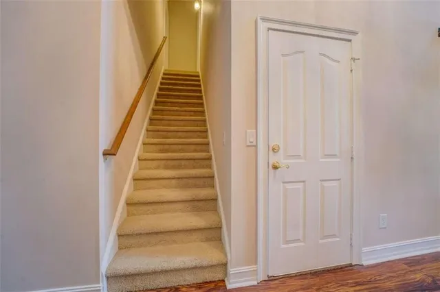an empty room with windows and chandelier fan