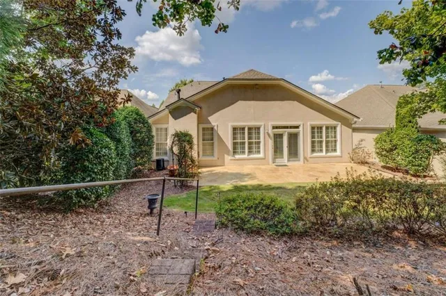 a view of a yard with plants and trees