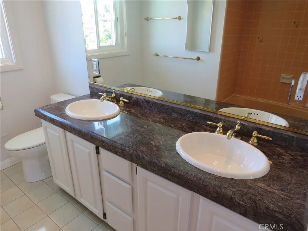 2507 Sunnyside Ridge Road Rancho Palos Verdes, CA 90275 - Photo 13 of 28 a bathroom with a sink and a mirror