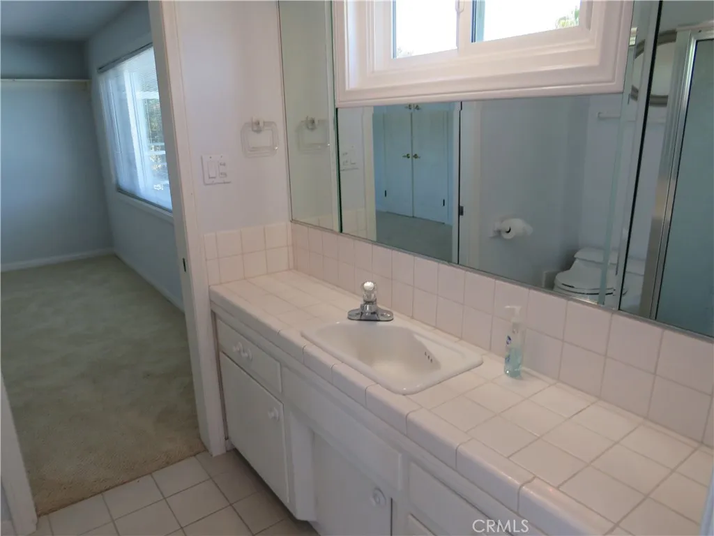 2507 Sunnyside Ridge Road Rancho Palos Verdes, CA 90275 - Photo 14 of 28 a bathroom with a sink and a mirror