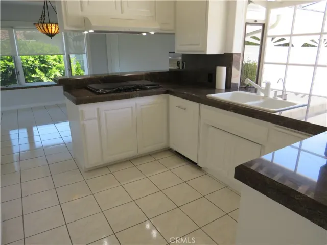 a kitchen with appliances and a refrigerator
