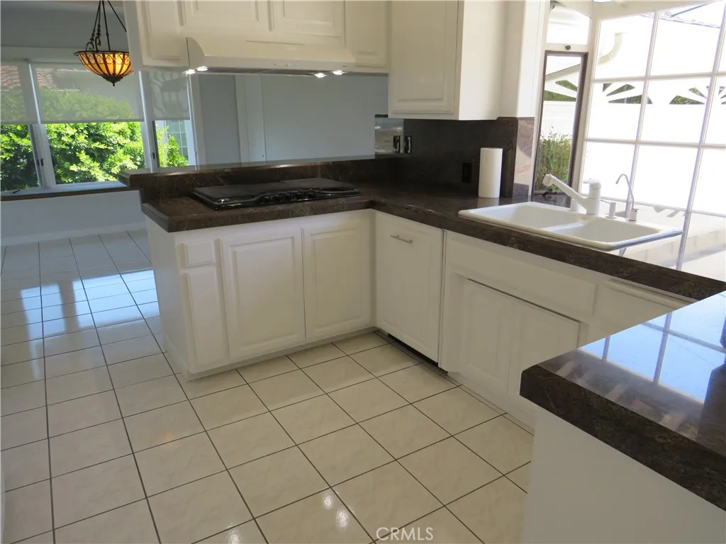 2507 Sunnyside Ridge Road Rancho Palos Verdes, CA 90275 - Photo 4 of 28 a kitchen with a sink and cabinets