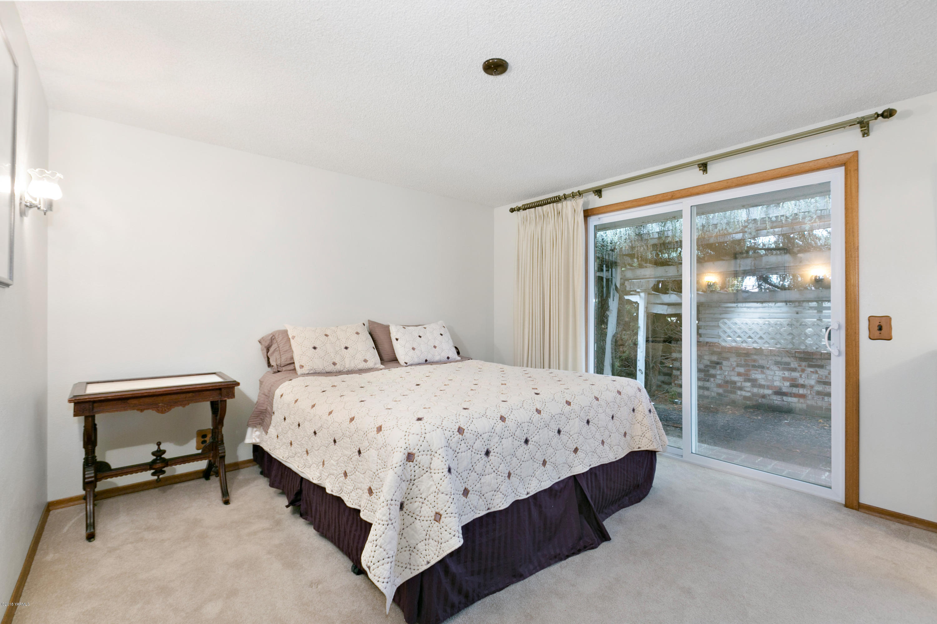 511 South Hennessy Road Yakima, WA 98908 - Photo 10 of 26 a bedroom with a bed and wooden floor