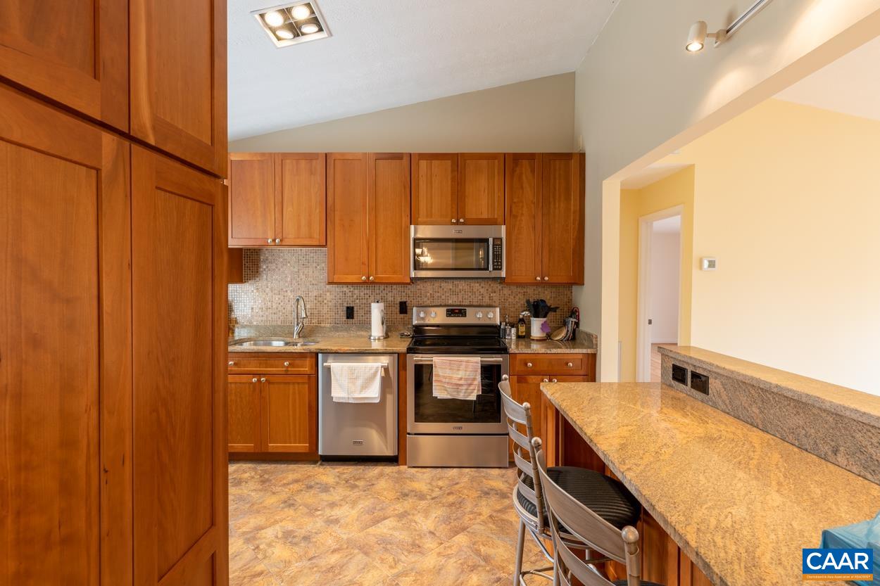 938 Jefferson Drive Palmyra, VA 22963 - Photo 11 of 50 a kitchen with stainless steel appliances granite countertop wooden cabinets a stove top oven a sink and dishwasher