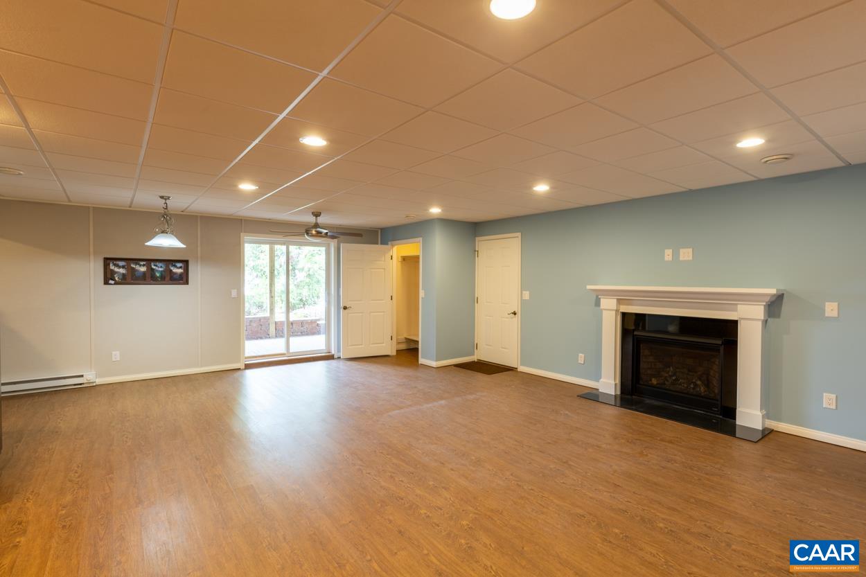938 Jefferson Drive Palmyra, VA 22963 - Photo 30 of 50 an empty room with wooden floor and fireplace