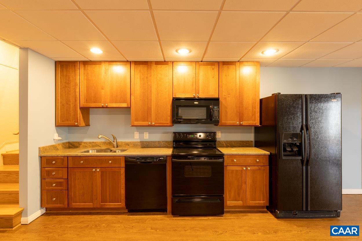 938 Jefferson Drive Palmyra, VA 22963 - Photo 31 of 50 a kitchen with stainless steel appliances granite countertop a refrigerator a sink and a stove