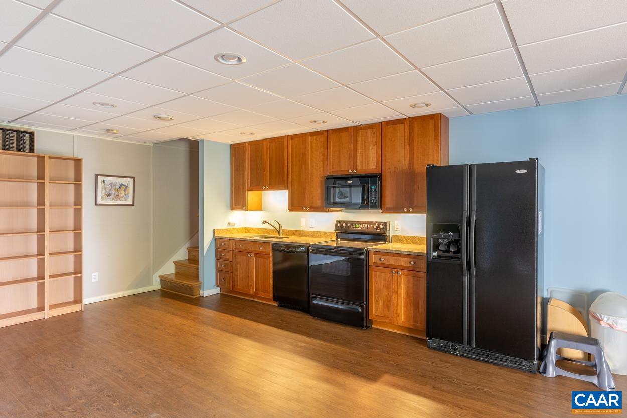 938 Jefferson Drive Palmyra, VA 22963 - Photo 34 of 50 a kitchen with stainless steel appliances granite countertop a refrigerator a stove and a sink with wooden floor