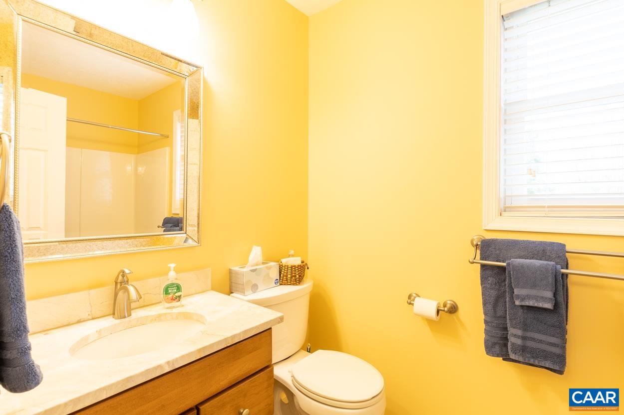 938 Jefferson Drive Palmyra, VA 22963 - Photo 43 of 50 a bathroom with a granite countertop sink toilet and mirror