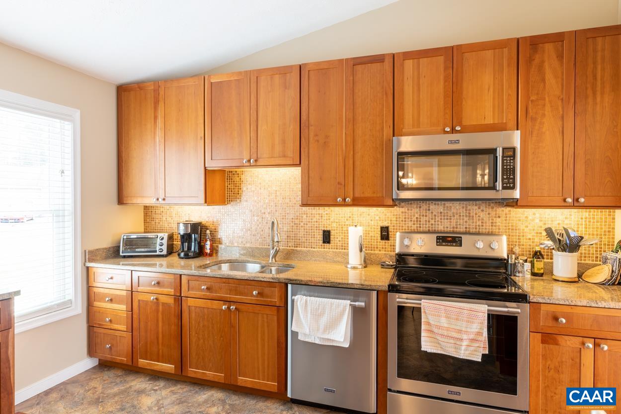 938 Jefferson Drive Palmyra, VA 22963 - Photo 8 of 50 a kitchen with stainless steel appliances granite countertop a sink stove and microwave
