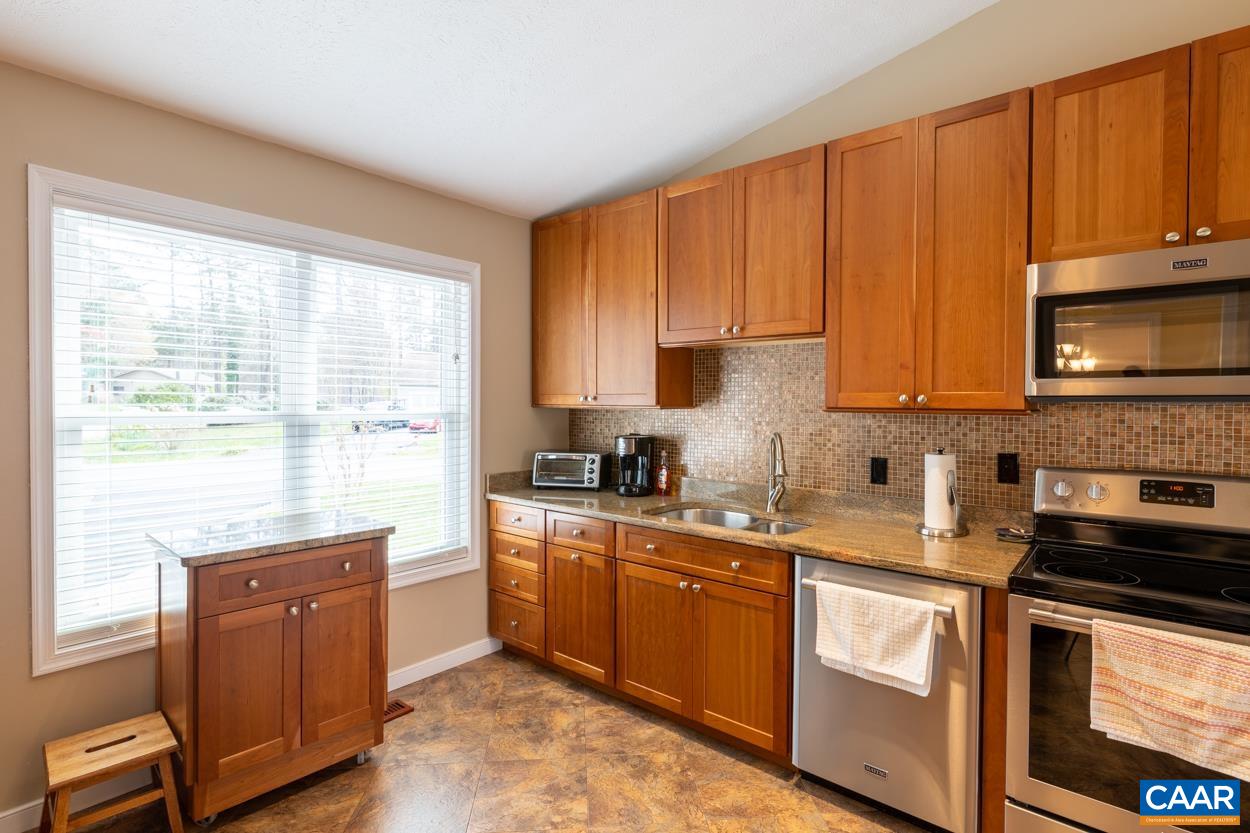 938 Jefferson Drive Palmyra, VA 22963 - Photo 10 of 50 a kitchen with stainless steel appliances granite countertop a stove a sink dishwasher and a microwave oven with cabinets