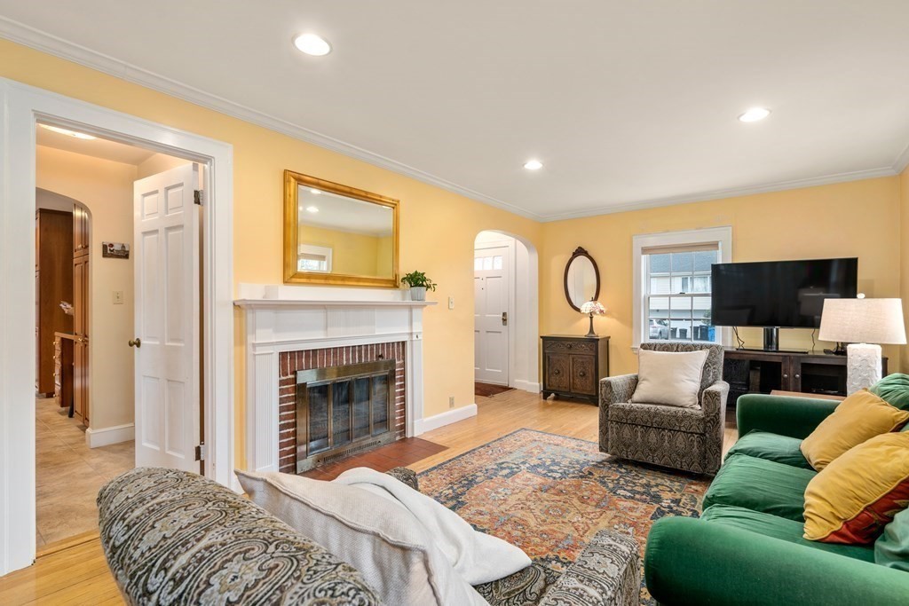 33 Taylor Road Belmont, MA 02478 - Photo 3 of 26 a living room with furniture a fireplace and a flat screen tv