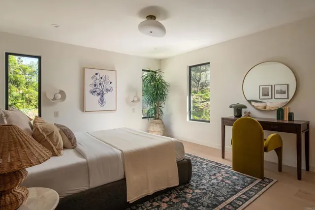 a spacious bedroom with a bed a couch and dresser