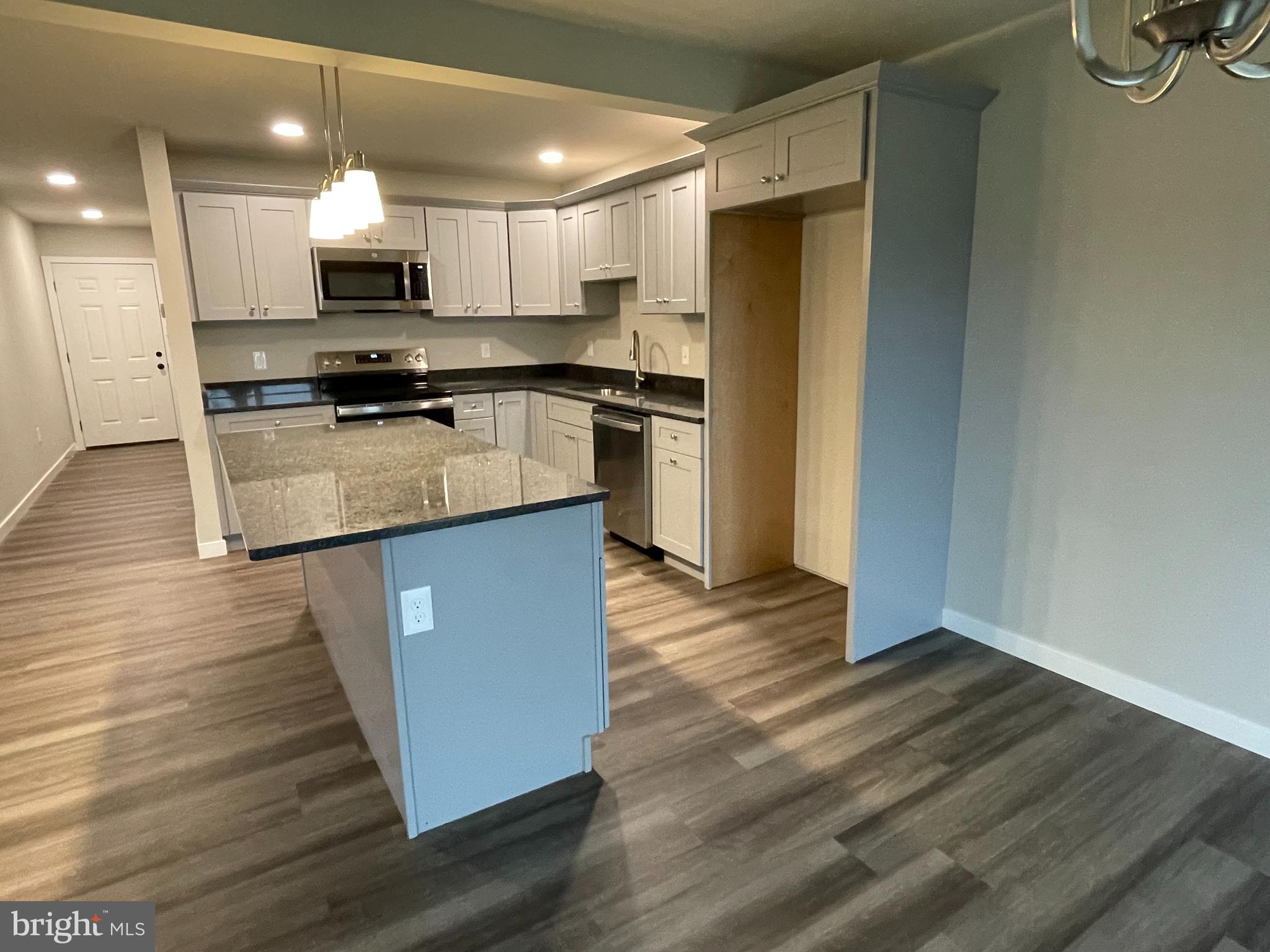 6173 Rizzuto Way Coopersburg, PA 18036 - Photo 4 of 21 a kitchen with kitchen island wooden floors appliances and cabinets