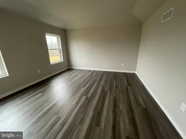 a view of wooden floor in an empty room