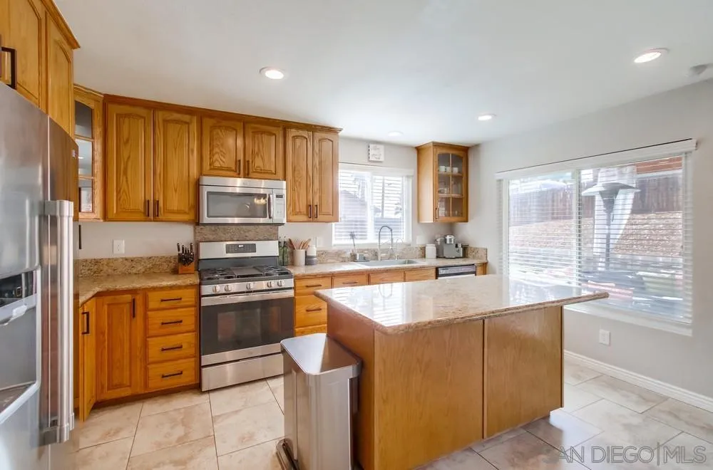 9118 Gotta Place Lakeside, CA 92040 - Photo 12 of 50 a kitchen with stainless steel appliances granite countertop a stove a sink and a refrigerator