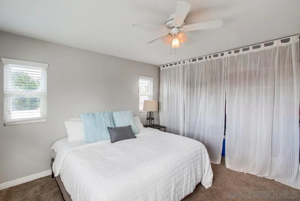 9118 Gotta Place Lakeside, CA 92040 - Photo 18 of 50 a bedroom with a bed and a chandelier
