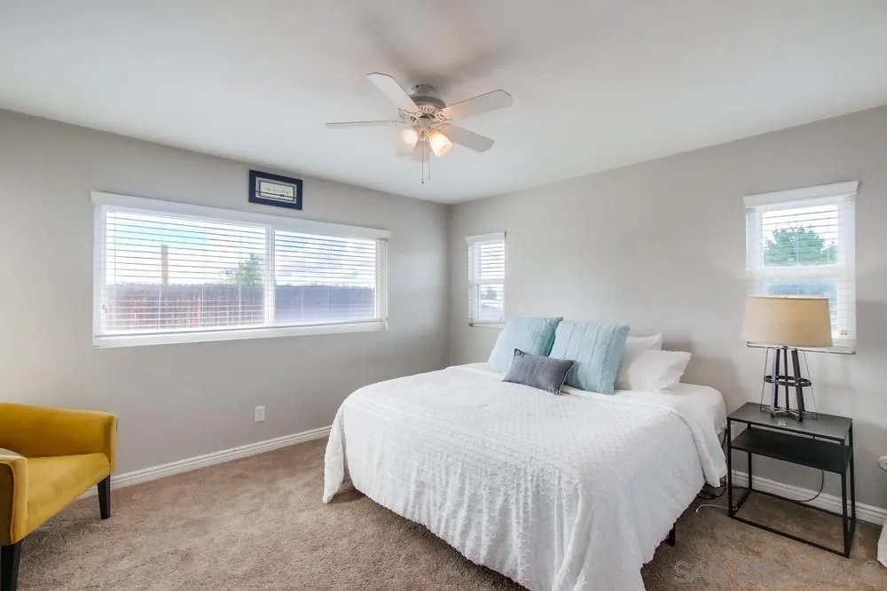9118 Gotta Place Lakeside, CA 92040 - Photo 21 of 50 a bedroom with a bed and a chandelier