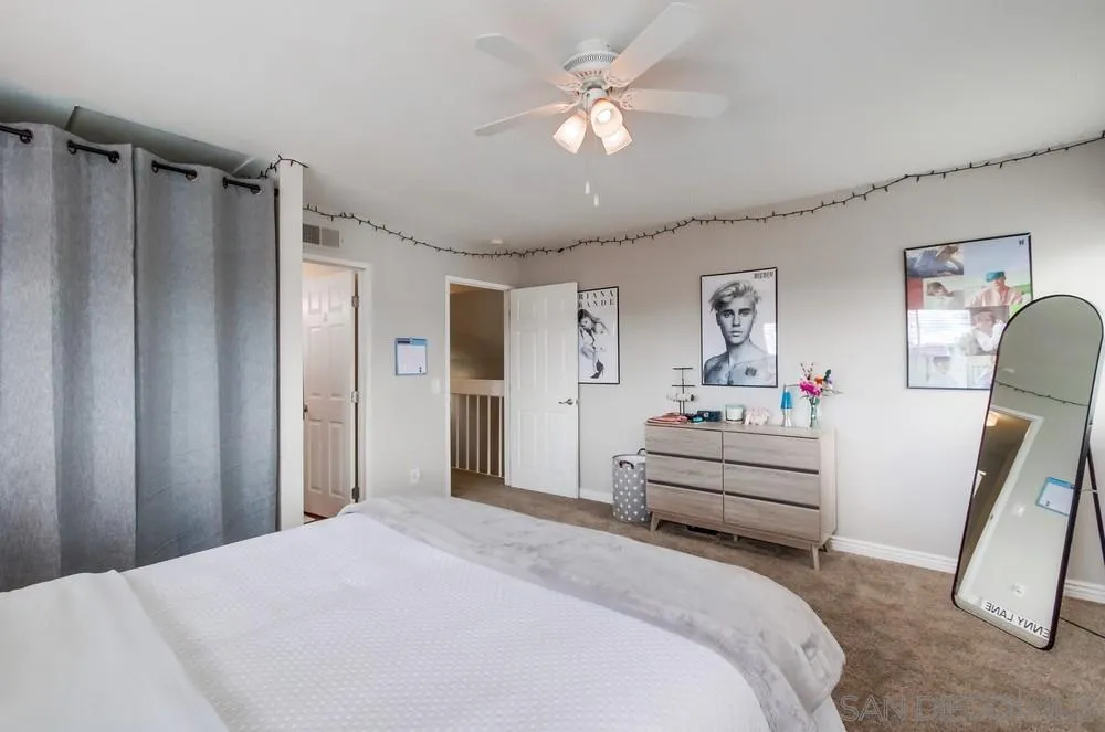 9118 Gotta Place Lakeside, CA 92040 - Photo 25 of 50 a bedroom with a bed and a chandelier