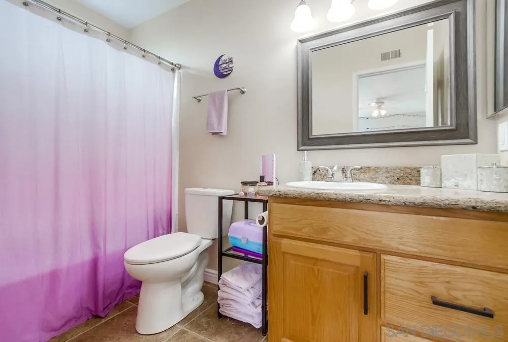 9118 Gotta Place Lakeside, CA 92040 - Photo 27 of 50 a bathroom with a sink toilet and mirror