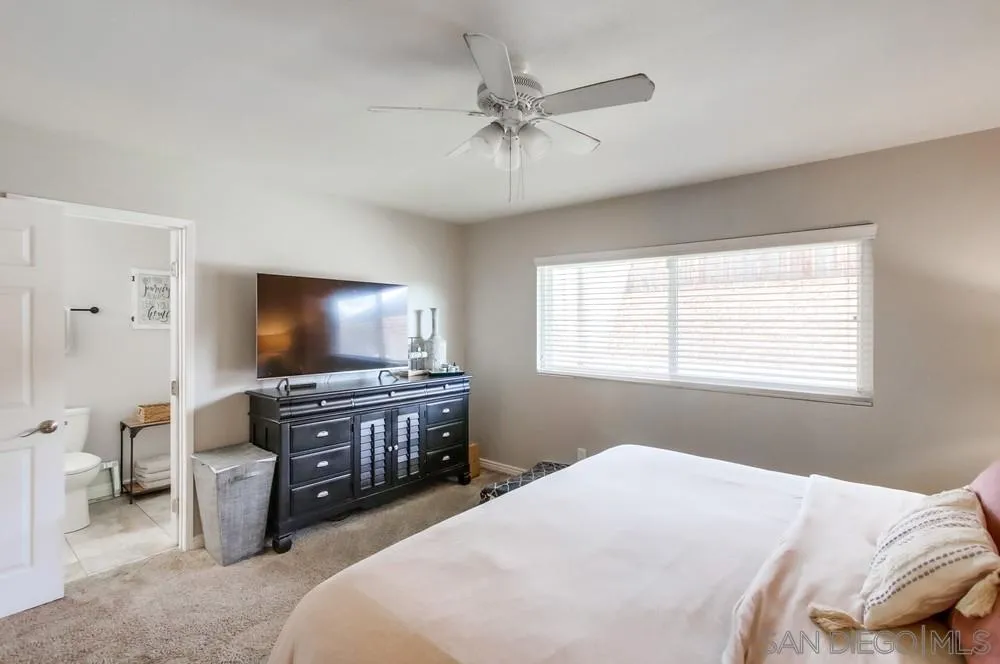 9118 Gotta Place Lakeside, CA 92040 - Photo 28 of 50 a bedroom with a bed and a flat screen tv