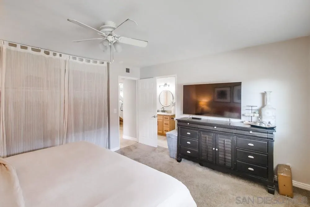 9118 Gotta Place Lakeside, CA 92040 - Photo 32 of 50 a bedroom with a bed and a flat screen tv