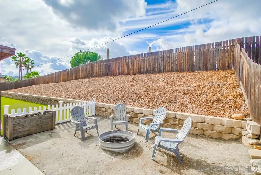 9118 Gotta Place Lakeside, CA 92040 - Photo 46 of 50 a view of a patio with table and chairs with wooden fence