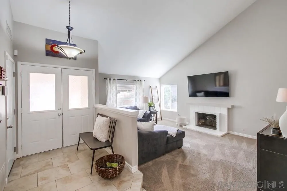9118 Gotta Place Lakeside, CA 92040 - Photo 5 of 50 a living room with furniture a flat screen tv and a fireplace