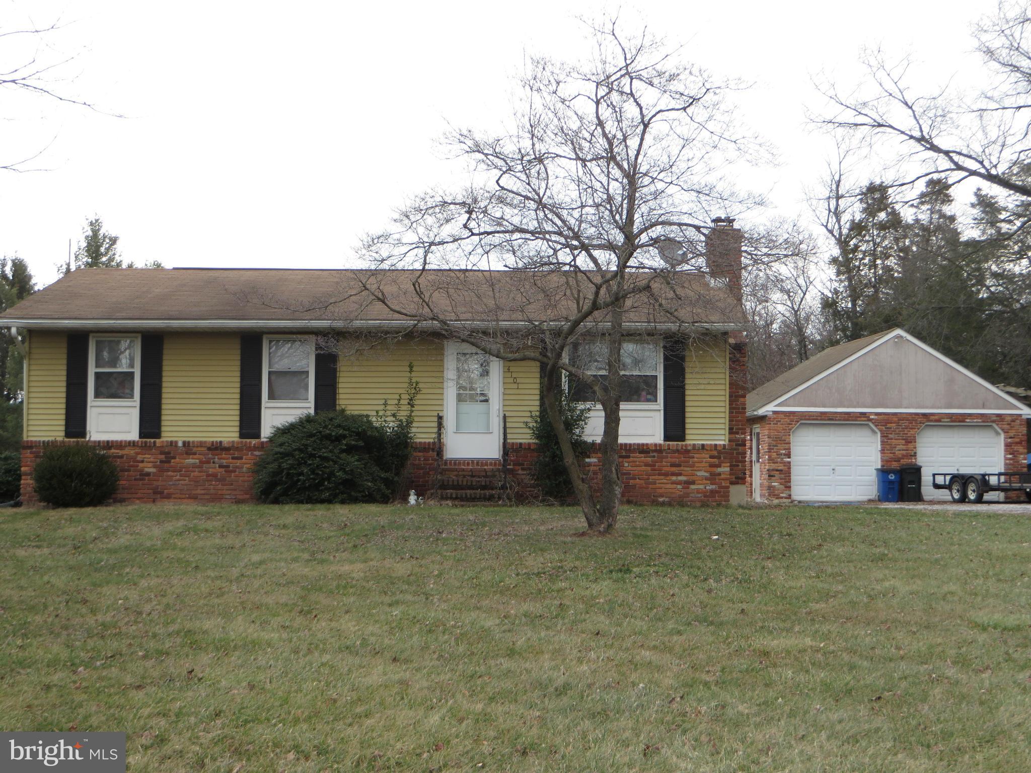 a front view of a house with a garden and yard
