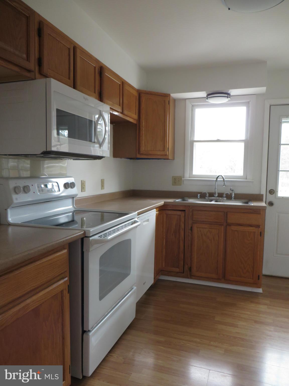 4101 Baptist Road Taneytown, MD 21787 - Photo 11 of 30 a kitchen with stainless steel appliances granite countertop a stove a sink and a microwave