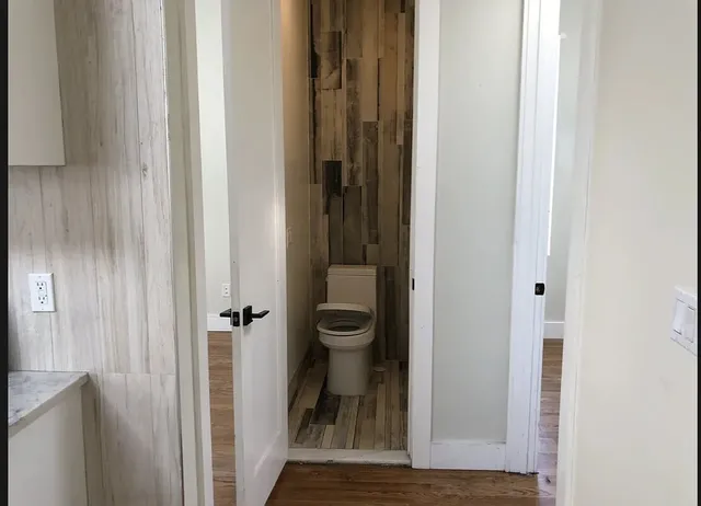 a view of a bathroom from a hallway