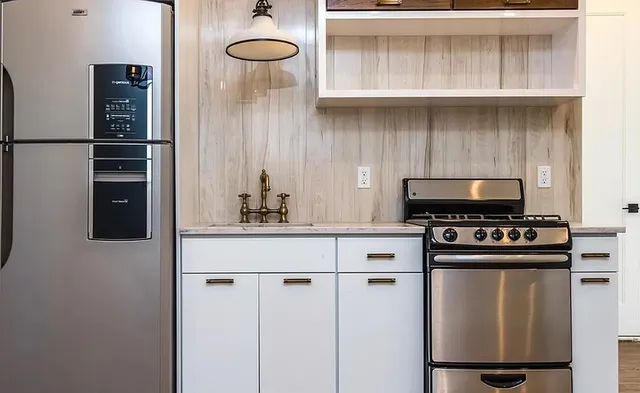 a kitchen with a stove and a refrigerator