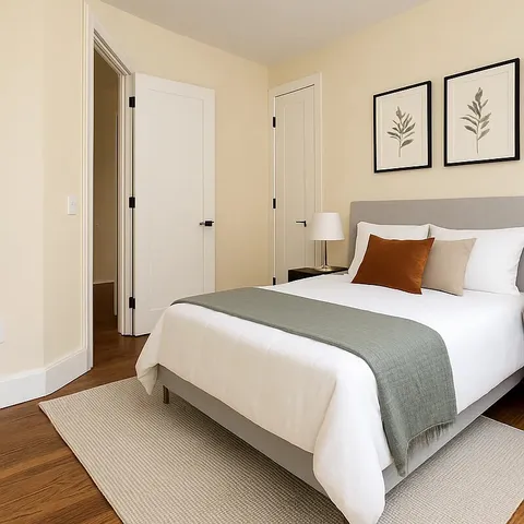 a bedroom with a bed and painting on the wall