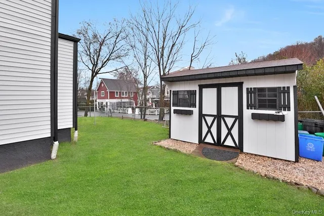 a view of a backyard with a garden and deck