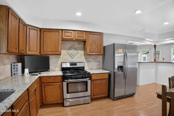 a kitchen with a stove microwave and refrigerator