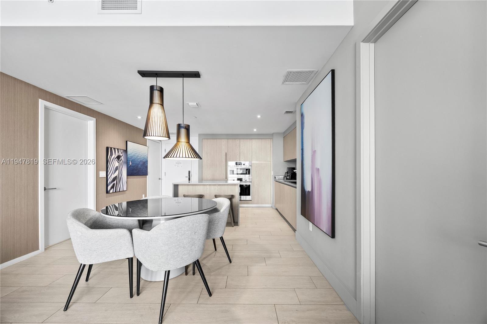 4010 South Ocean Drive, Unit R2307 Hollywood, FL 33019 - Photo 12 of 35 a dining room with furniture and wooden floor