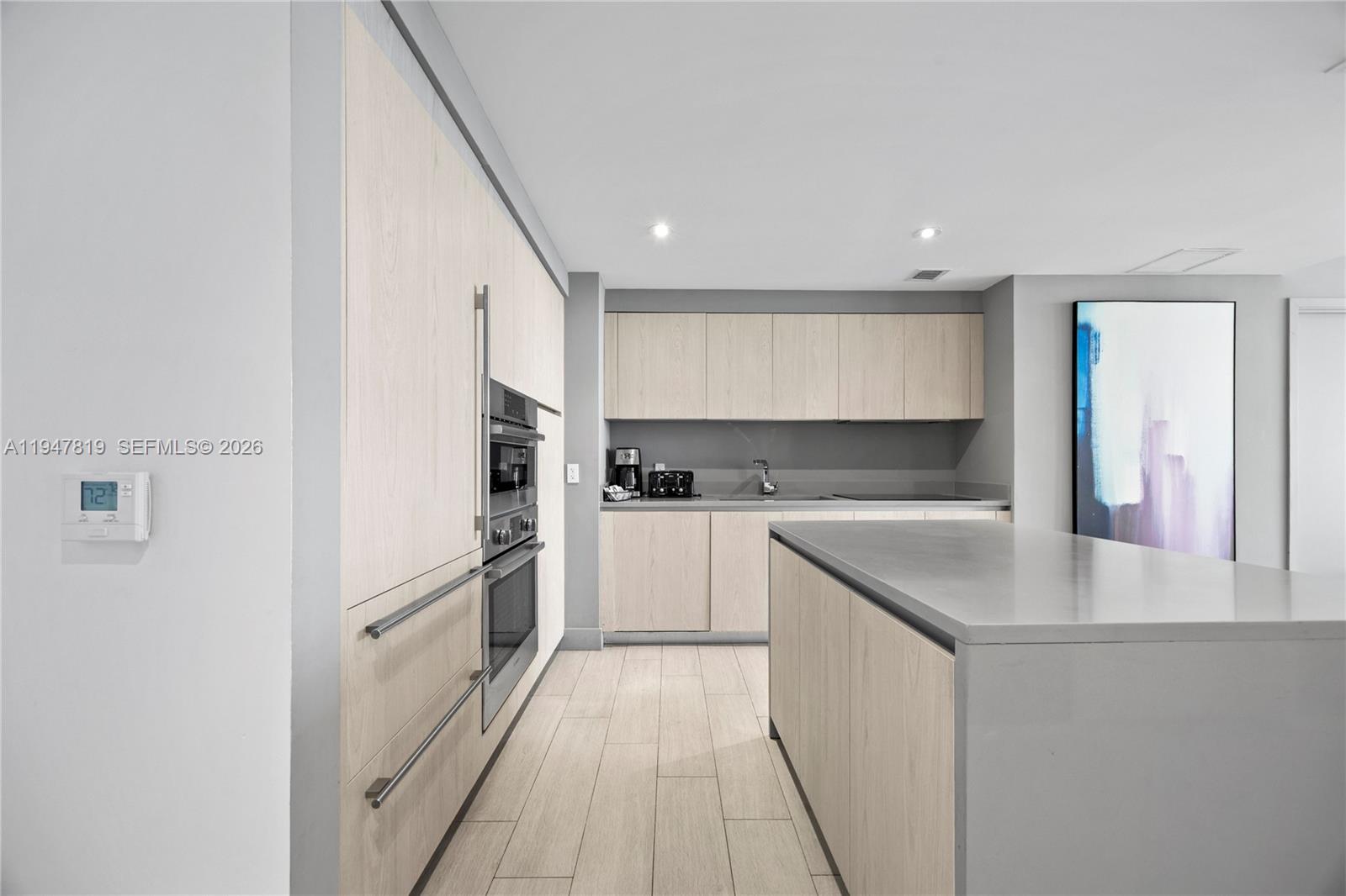 4010 South Ocean Drive, Unit R2307 Hollywood, FL 33019 - Photo 15 of 35 a kitchen with white cabinets appliances and a sink