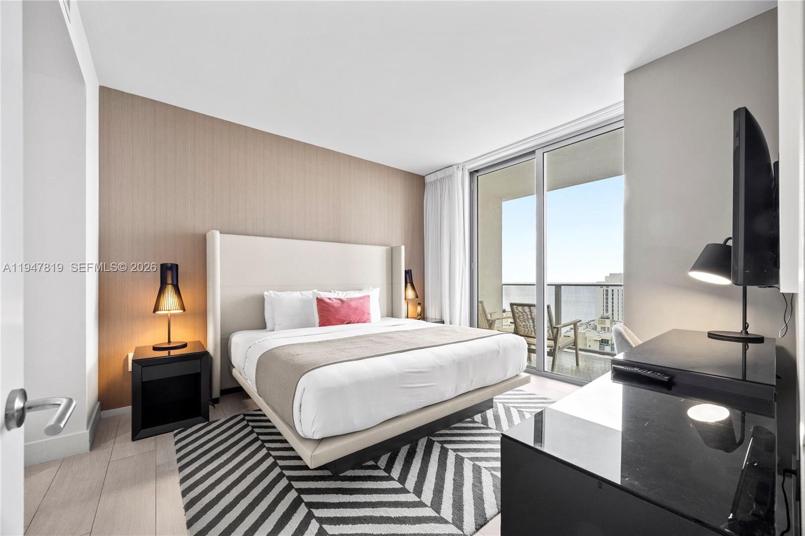 4010 South Ocean Drive, Unit R2307 Hollywood, FL 33019 - Photo 19 of 35 a bedroom with a bed and large windows