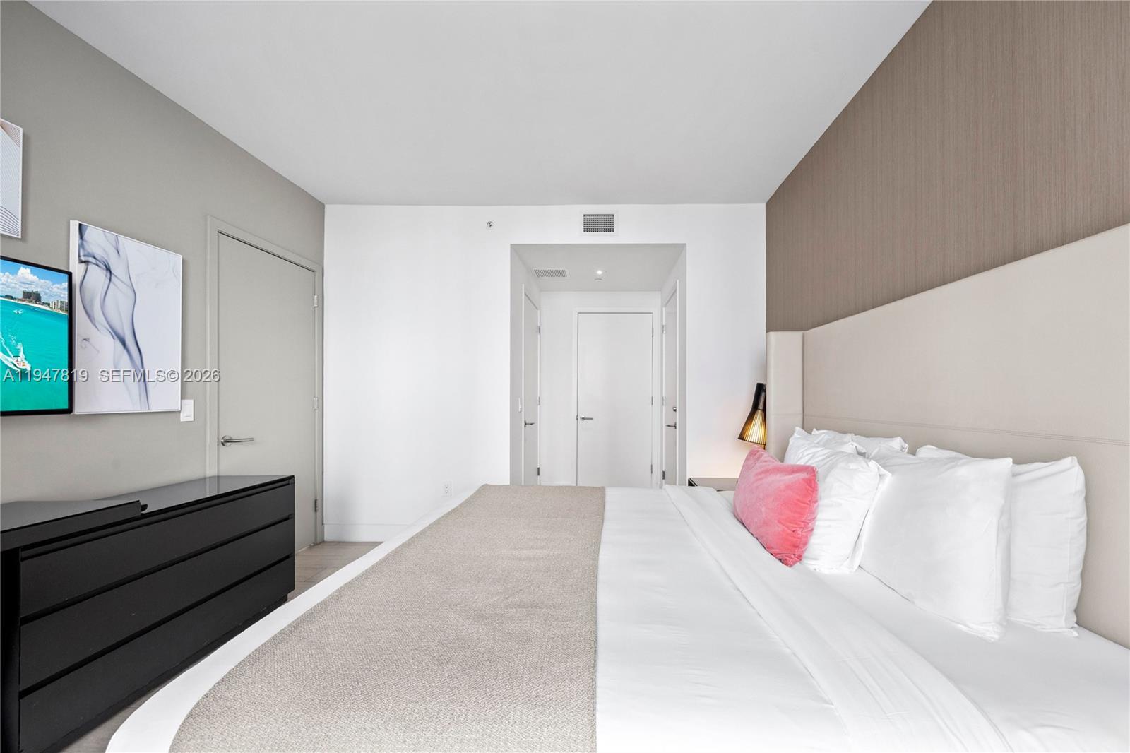 4010 South Ocean Drive, Unit R2307 Hollywood, FL 33019 - Photo 21 of 35 a bedroom with a bed and a window