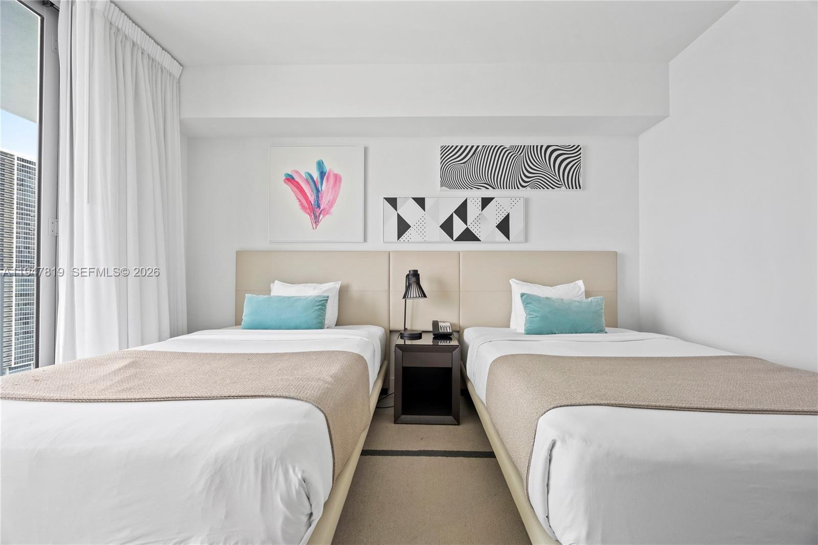 4010 South Ocean Drive, Unit R2307 Hollywood, FL 33019 - Photo 23 of 35 a bedroom with two beds and book shelf