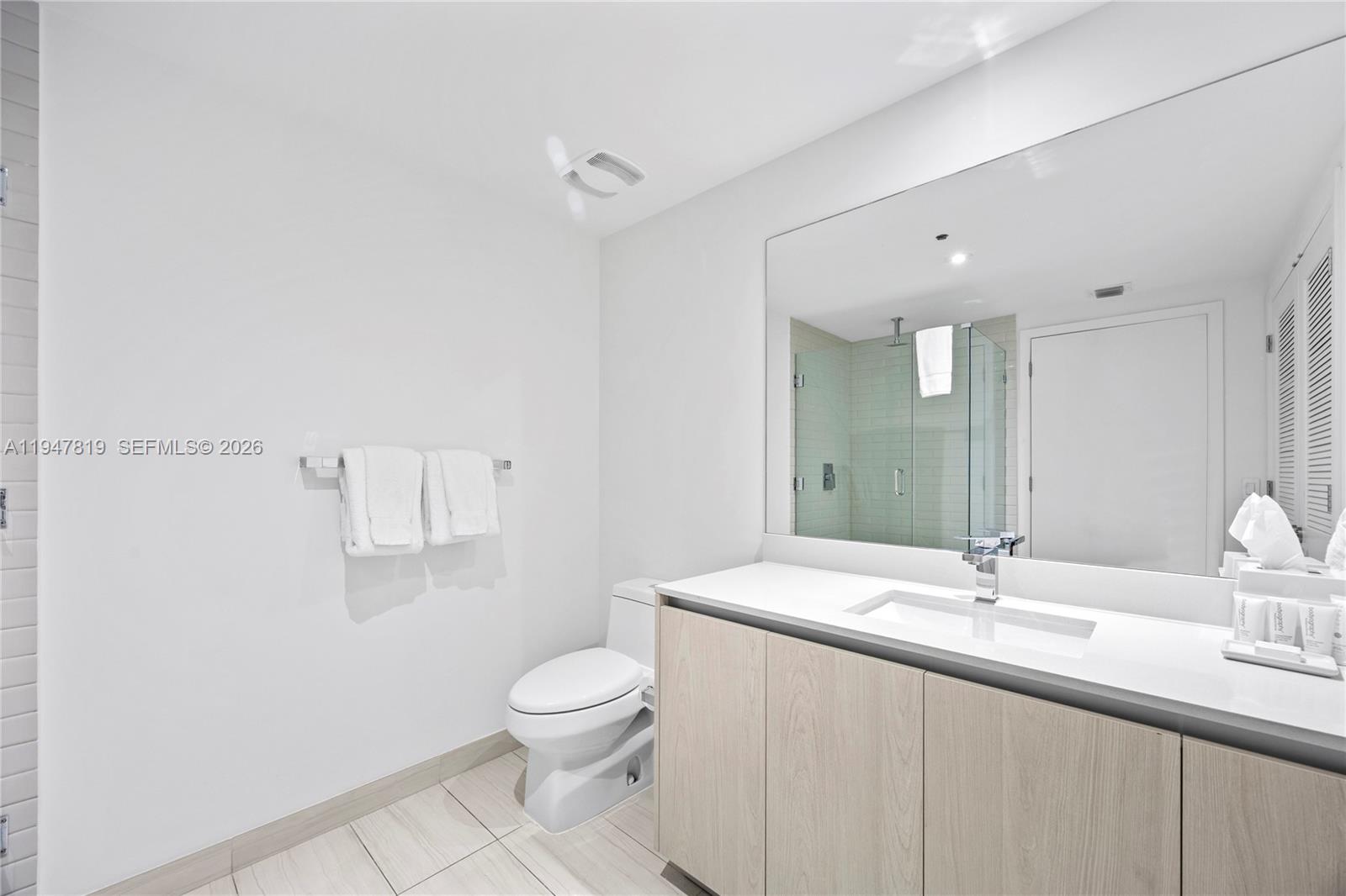 4010 South Ocean Drive, Unit R2307 Hollywood, FL 33019 - Photo 32 of 35 a bathroom with a sink toilet and mirror