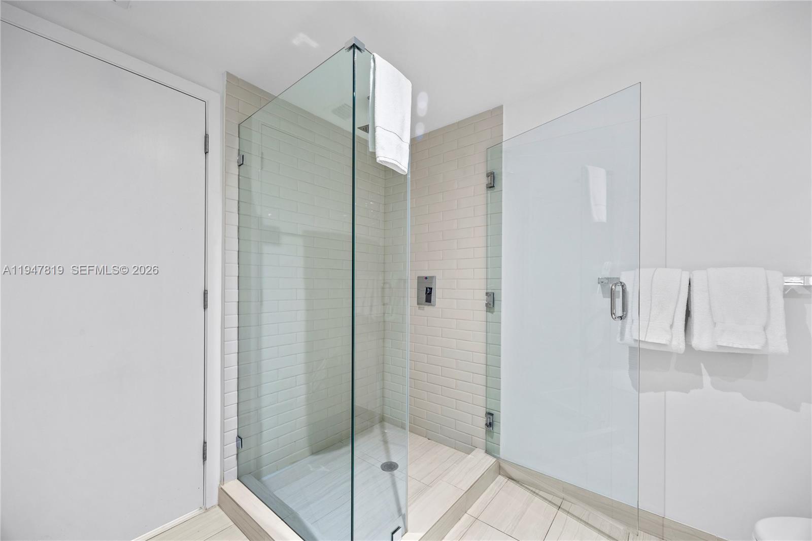 4010 South Ocean Drive, Unit R2307 Hollywood, FL 33019 - Photo 34 of 35 a bathroom with a glass shower door