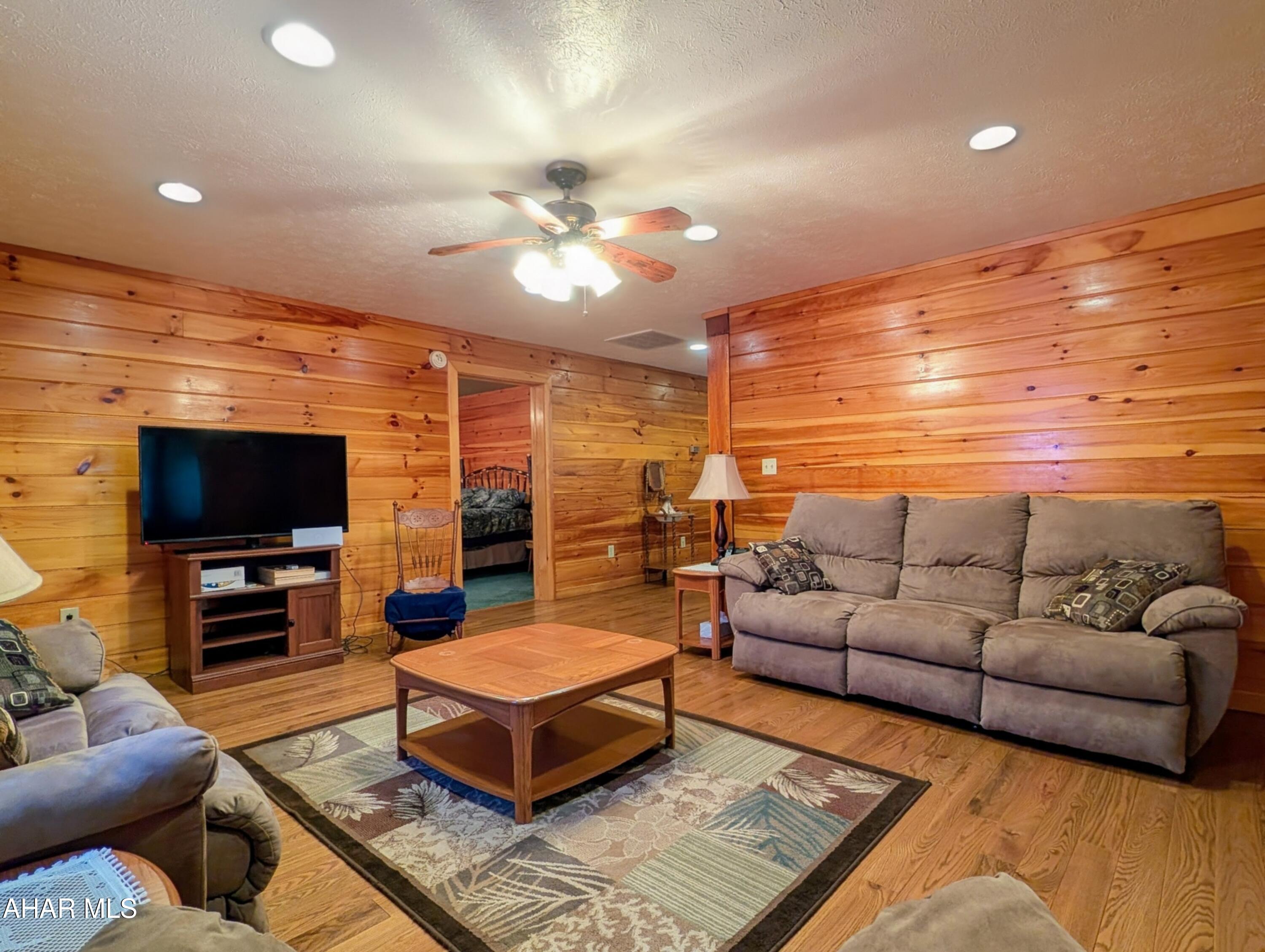 213 Sherman Valley Road Hopewell, PA 16650 - Photo 60 of 104 a living room with furniture and a flat screen tv