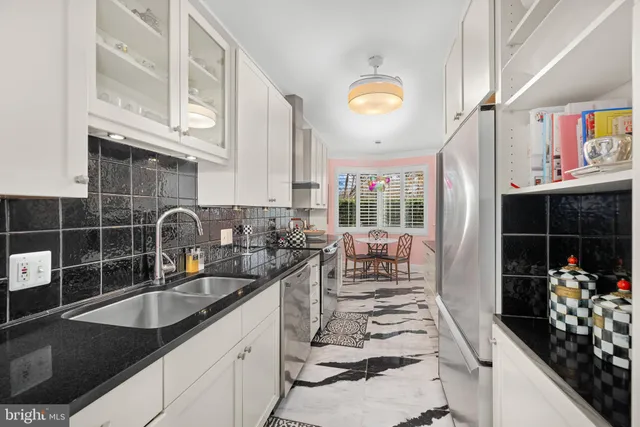 a kitchen with stainless steel appliances a sink stove and cabinets