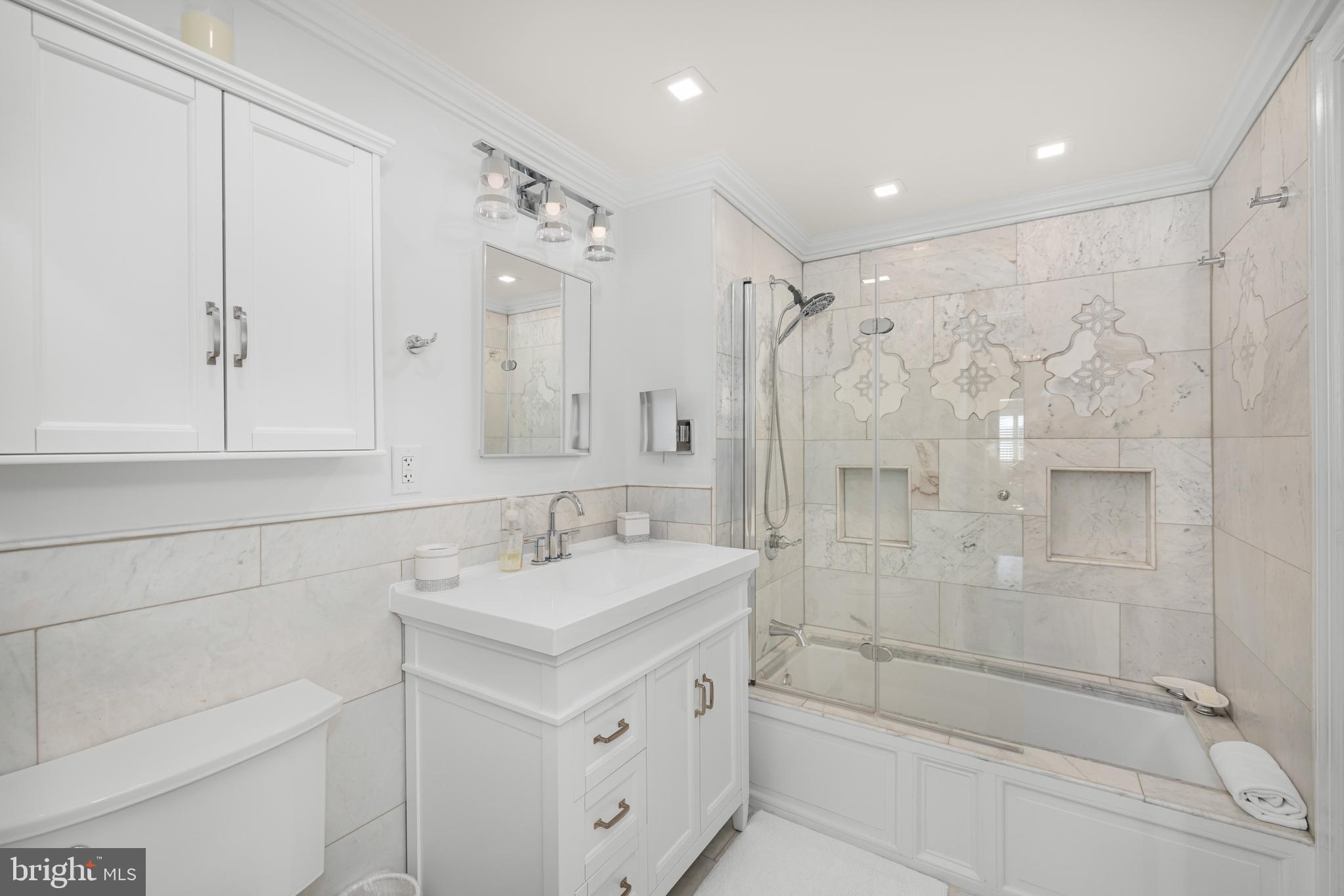 2801 New Mexico Avenue Northwest, Unit 204 Washington, DC 20007 - Photo 22 of 49 a bathroom with a shower sink vanity and mirror