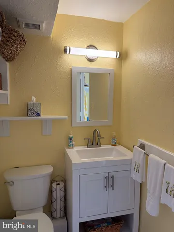 a view of a bedroom with wooden floor and a balcony